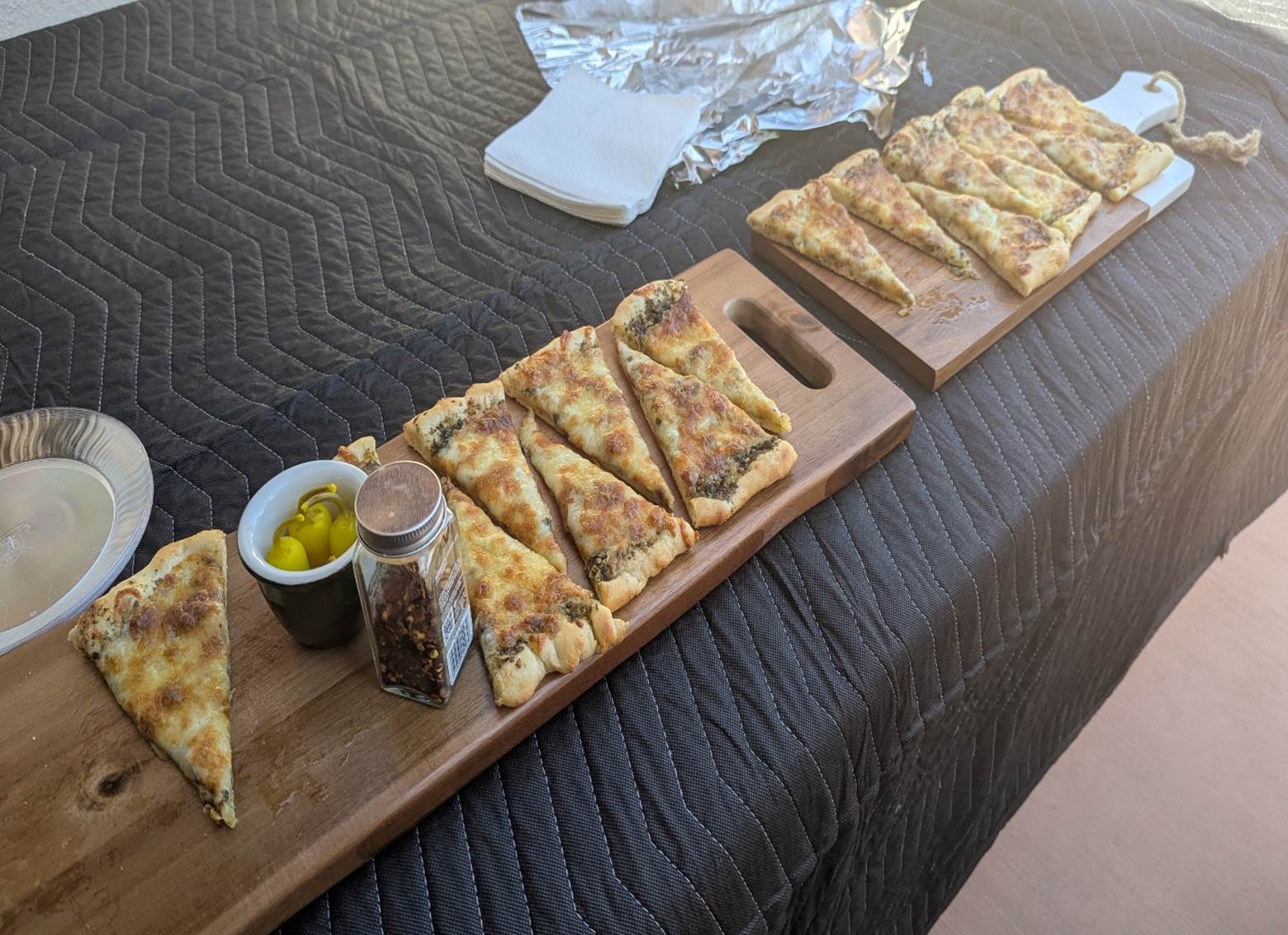 A wooden board with slices of pizza on it

AI-generated content may be incorrect.