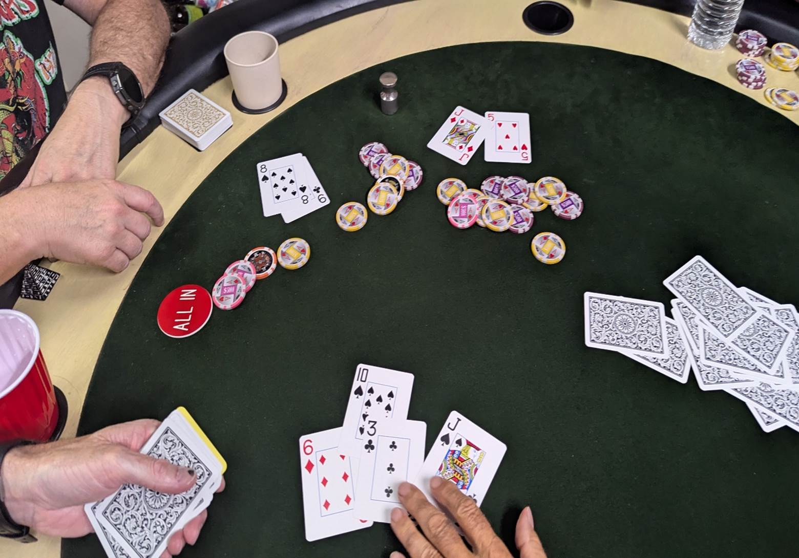 A poker table with cards and chips

AI-generated content may be incorrect.