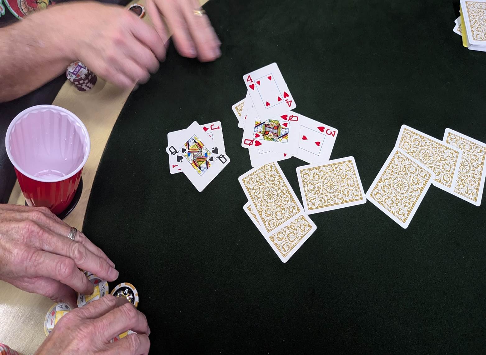 A close-up of a person playing cards

AI-generated content may be incorrect.