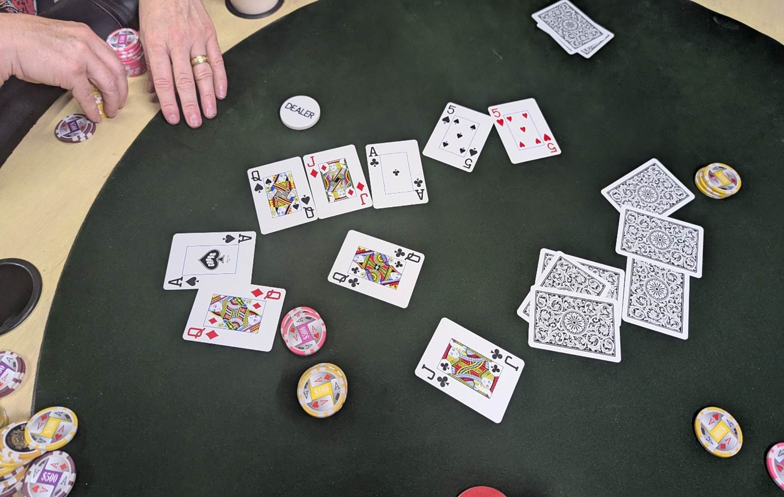 A close-up of cards and chips on a table

AI-generated content may be incorrect.