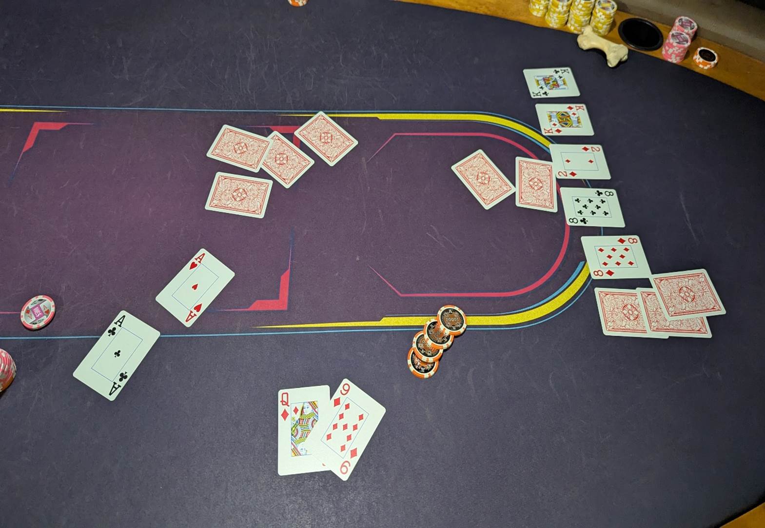 A close-up of cards and chips on a black surface

AI-generated content may be incorrect.