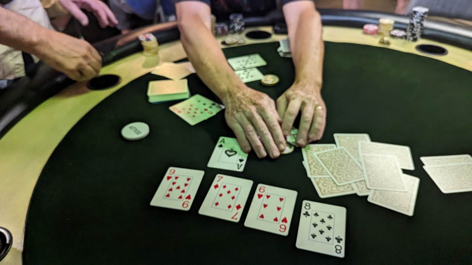 A person playing cards on a table

Description automatically generated