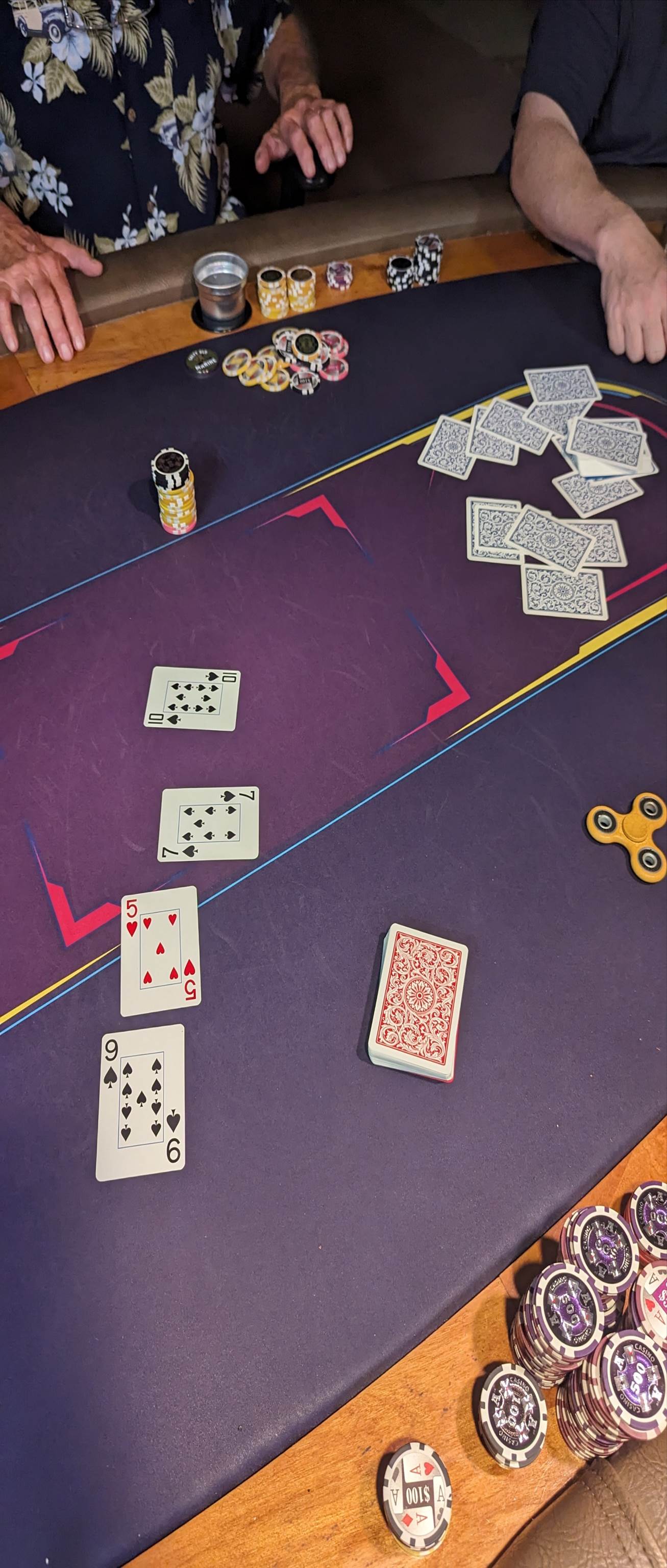 A person playing poker on a purple table

Description automatically generated