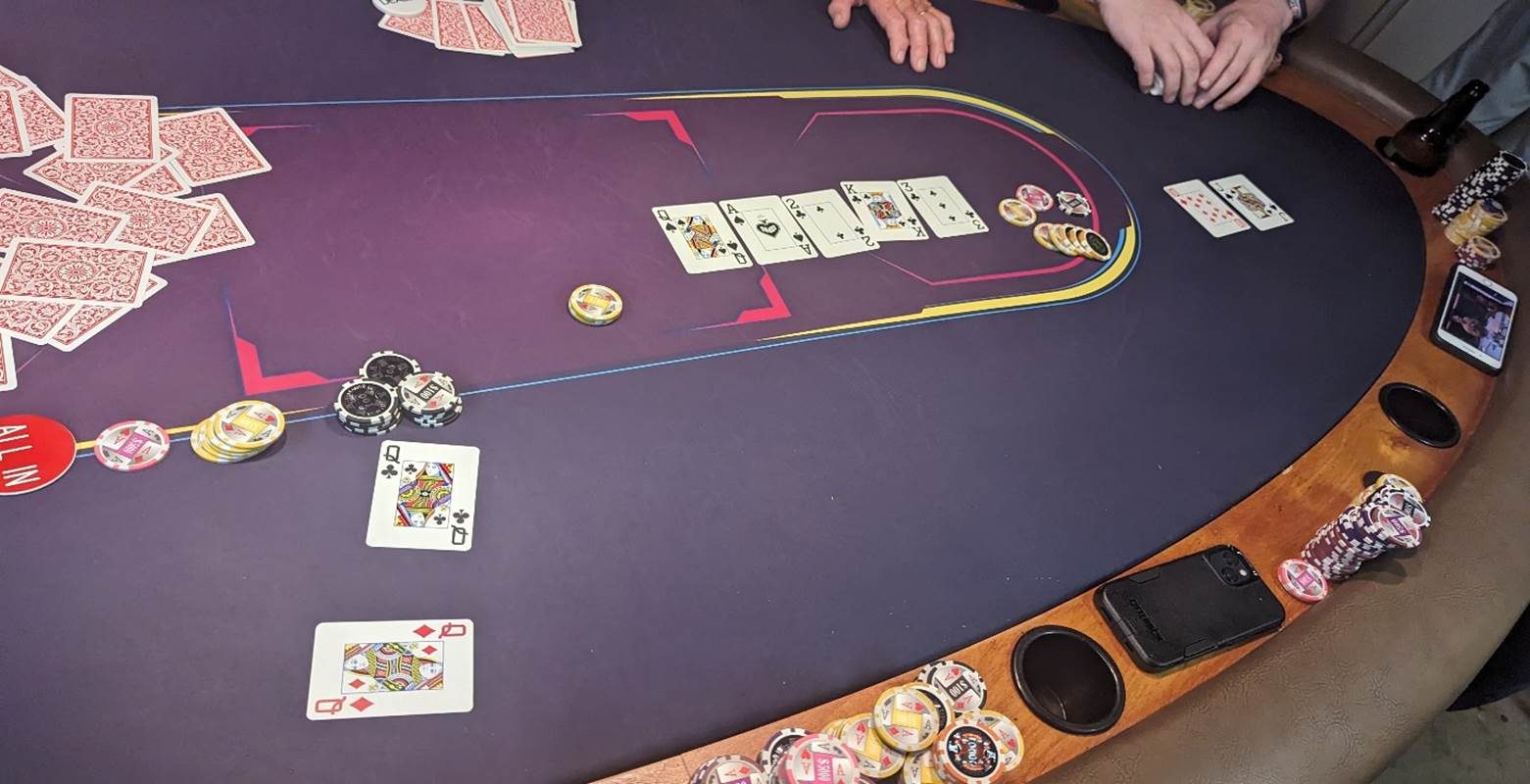 A poker table with cards and chips

Description automatically generated