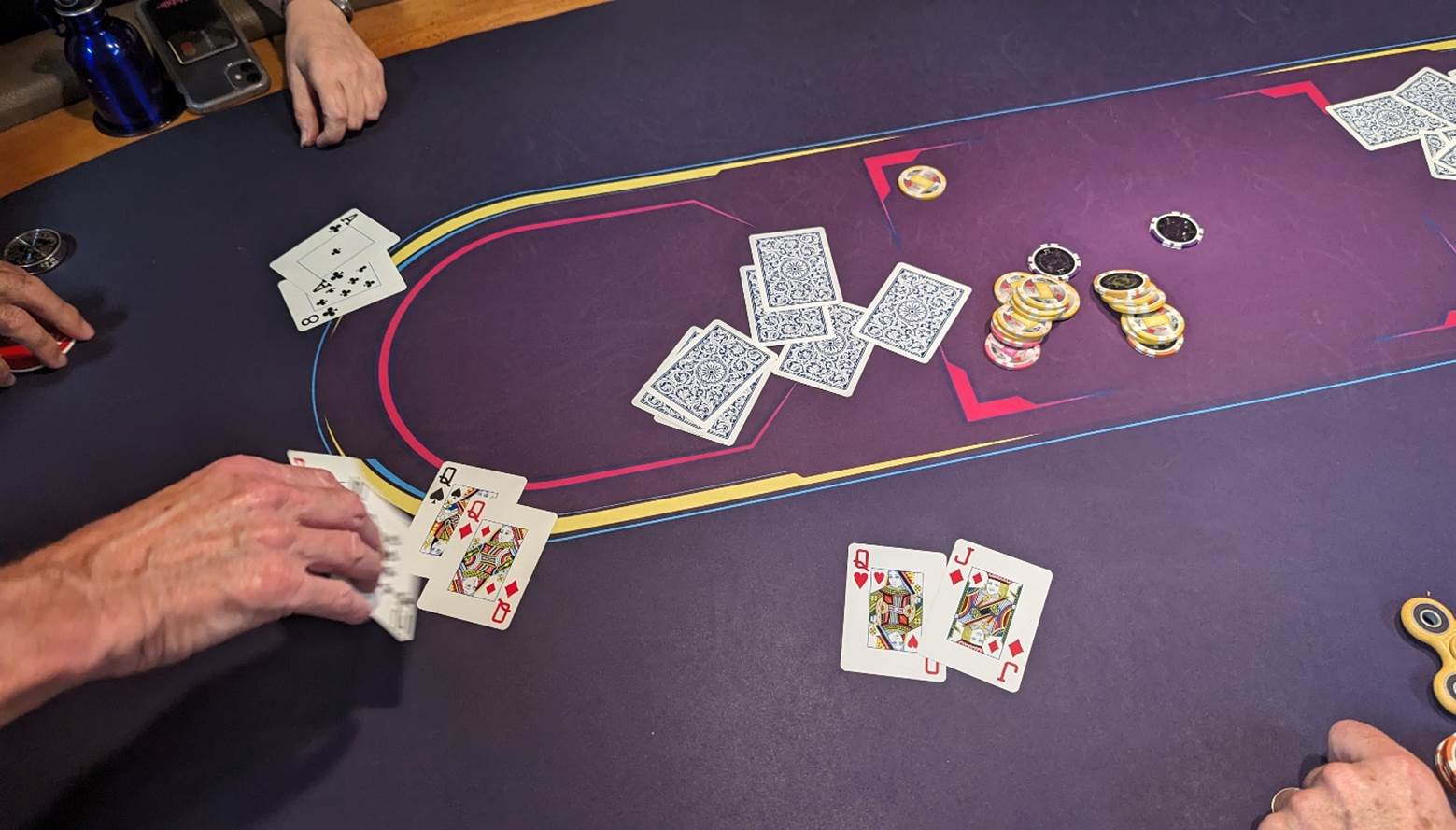 A person playing poker on a purple table

Description automatically generated