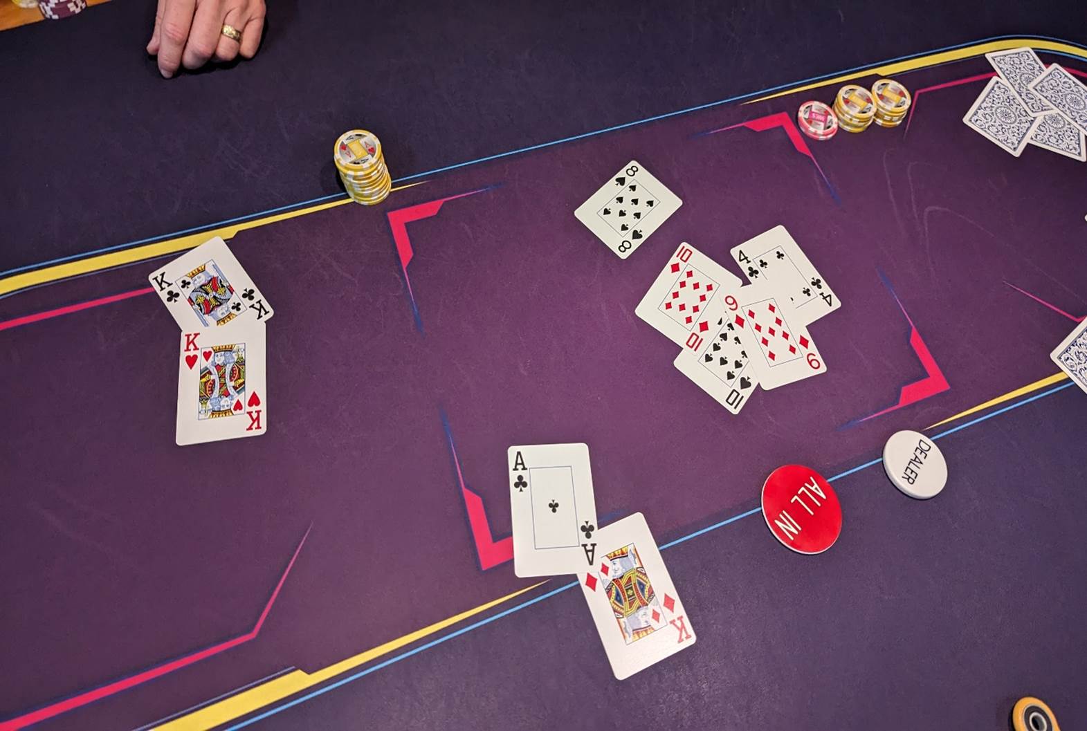 A poker table with cards and chips

Description automatically generated