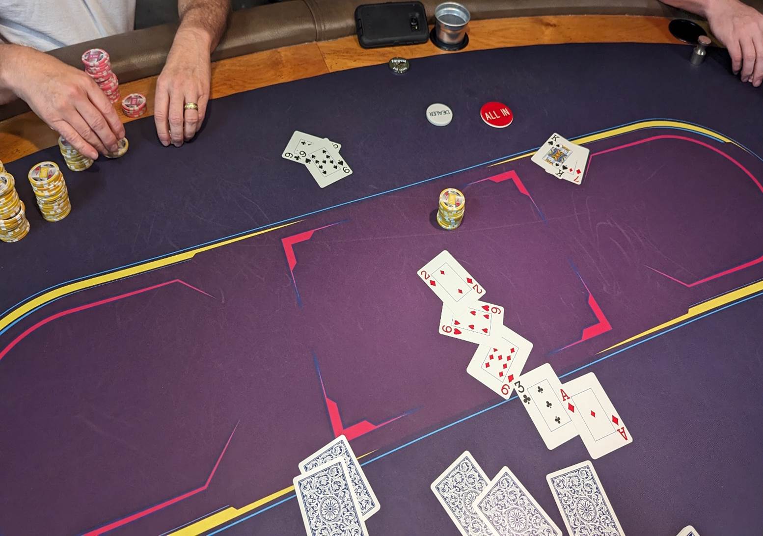 A person playing poker on a table

Description automatically generated