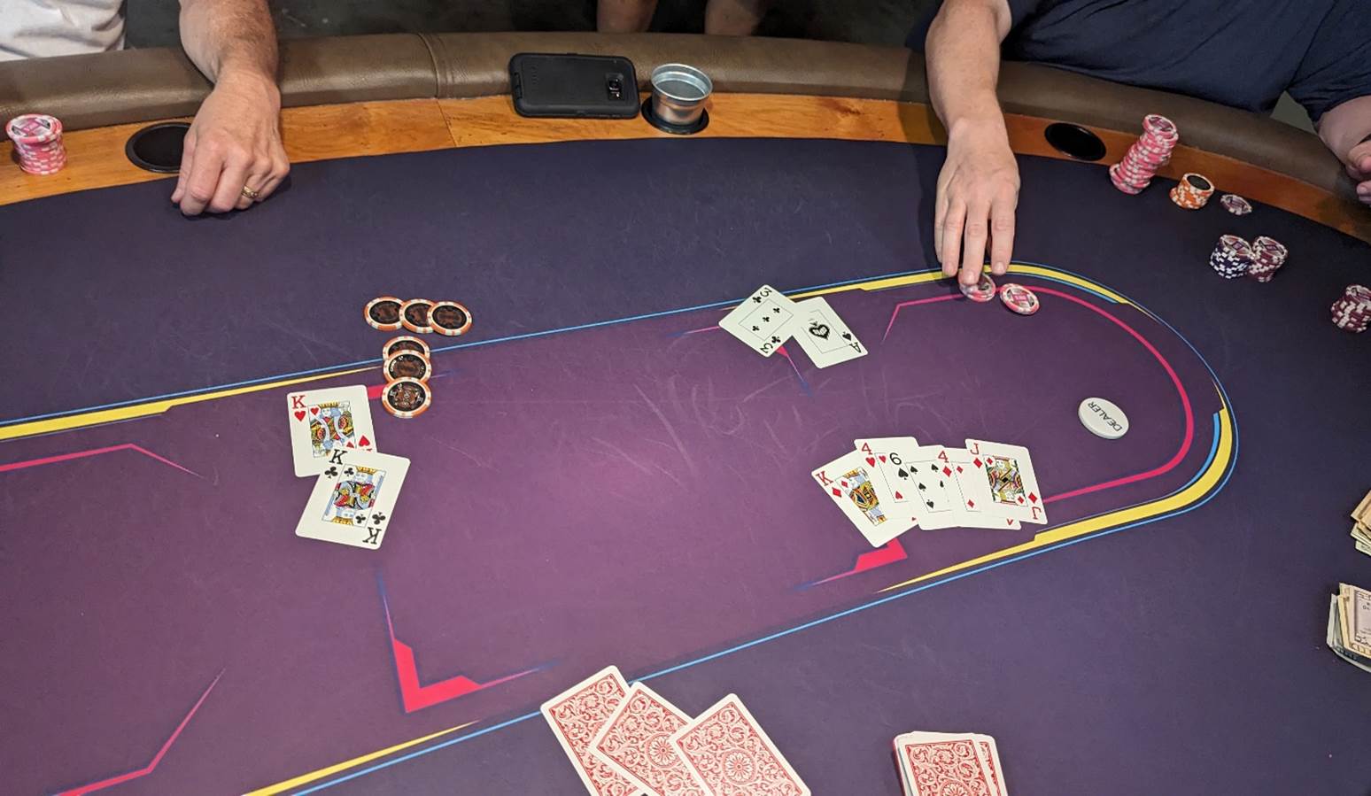 A person playing poker on a table

Description automatically generated