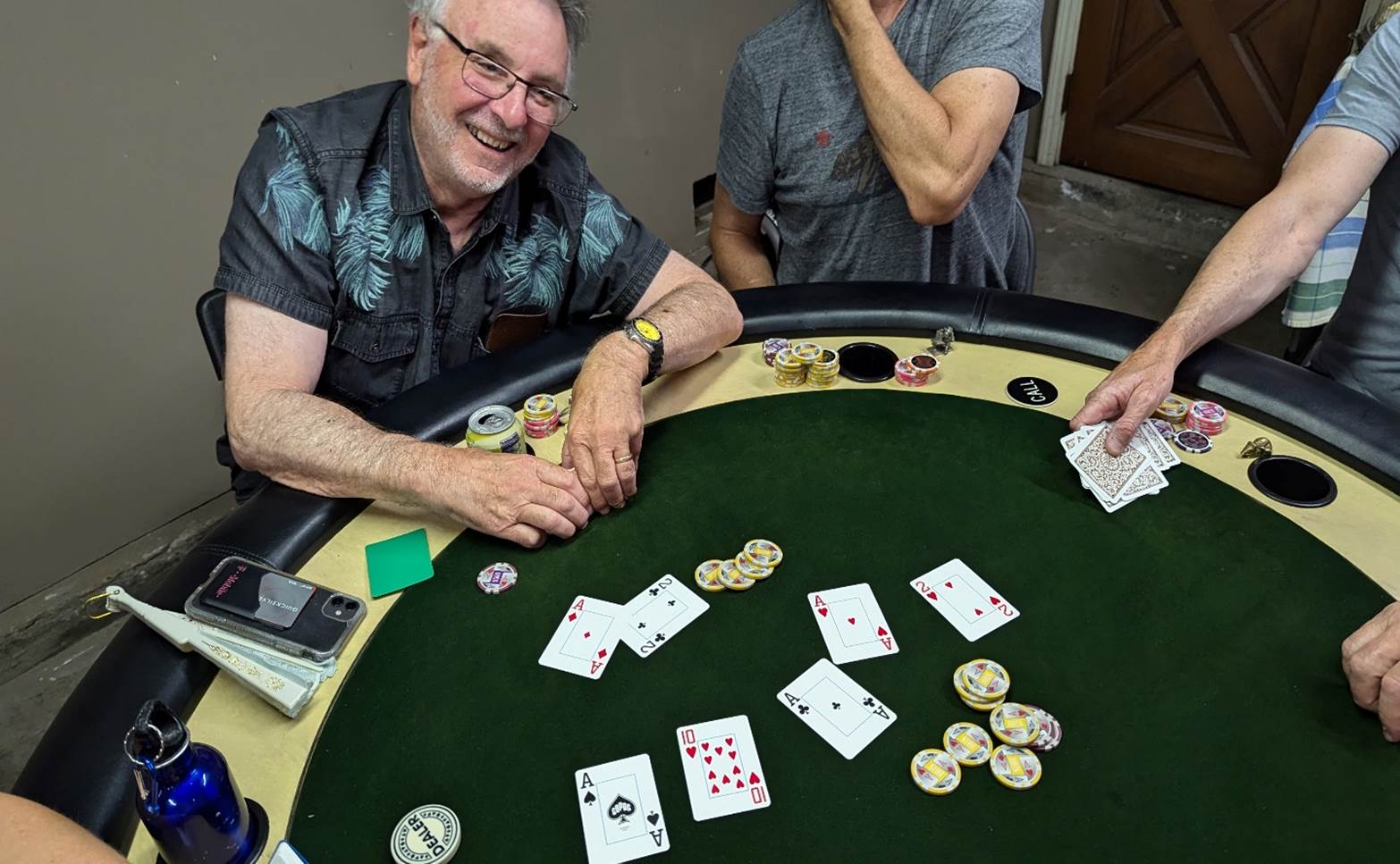 A person smiling at a poker table

Description automatically generated