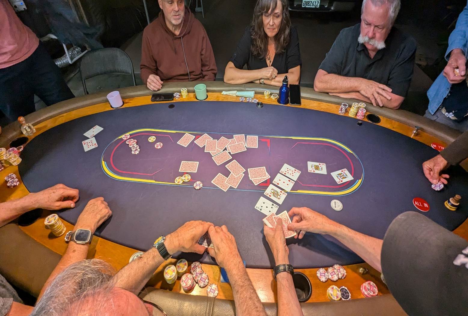 A group of people playing poker

Description automatically generated