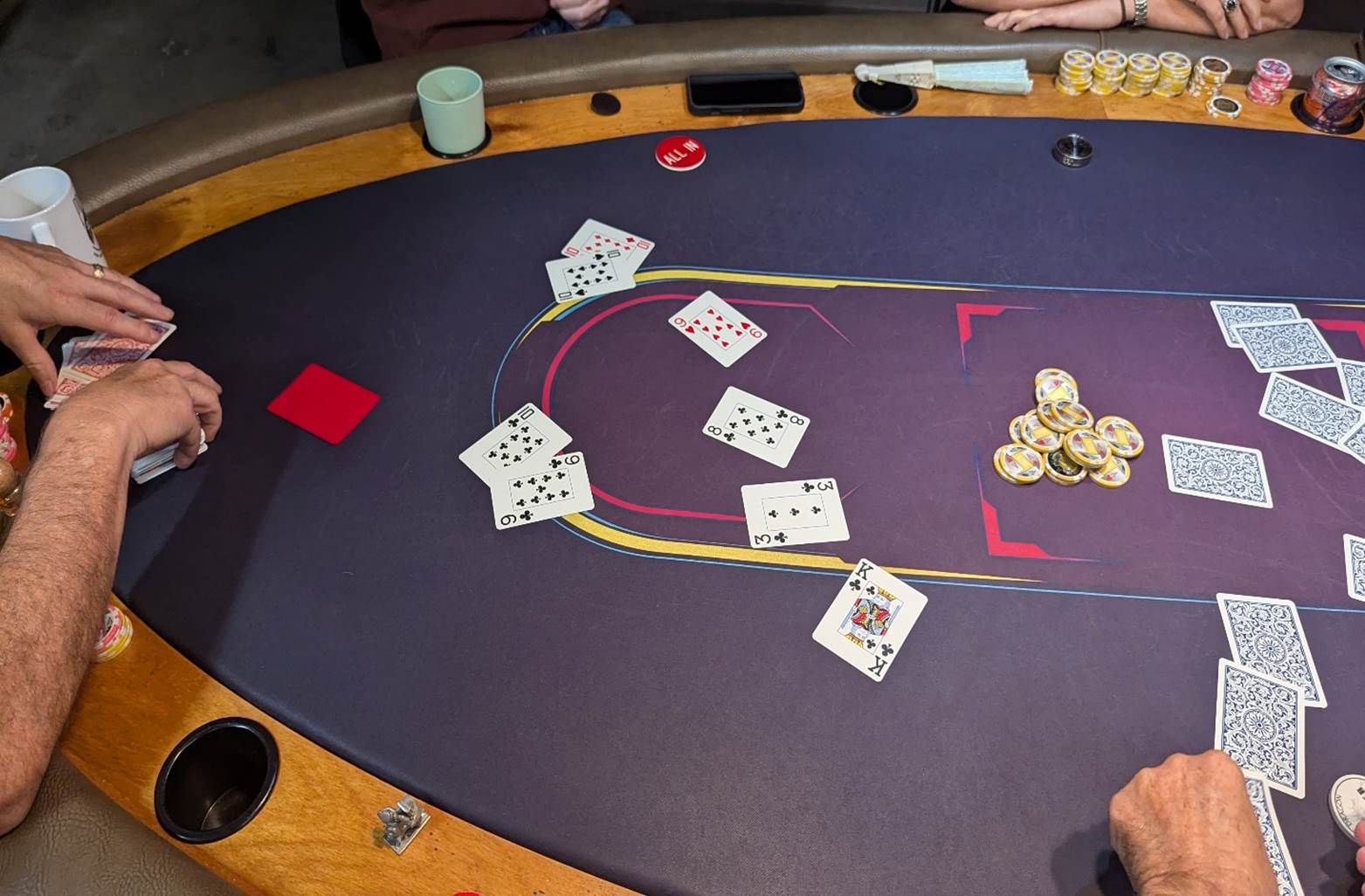 A poker table with cards and chips

Description automatically generated