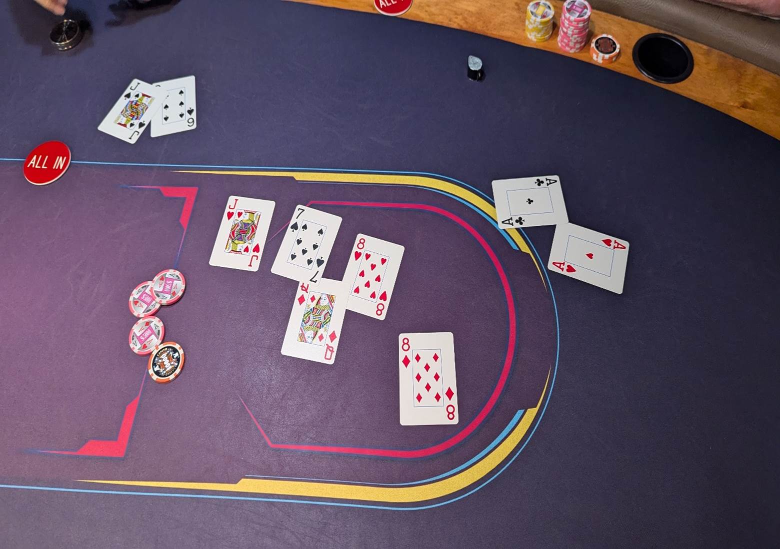 A poker table with playing cards and chips

Description automatically generated