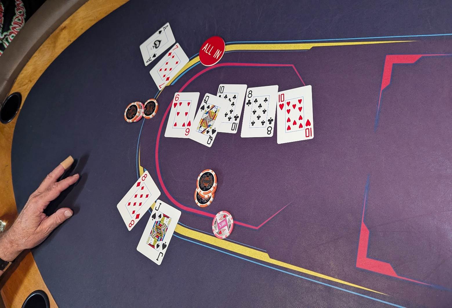A playing cards and chips on a purple surface

Description automatically generated