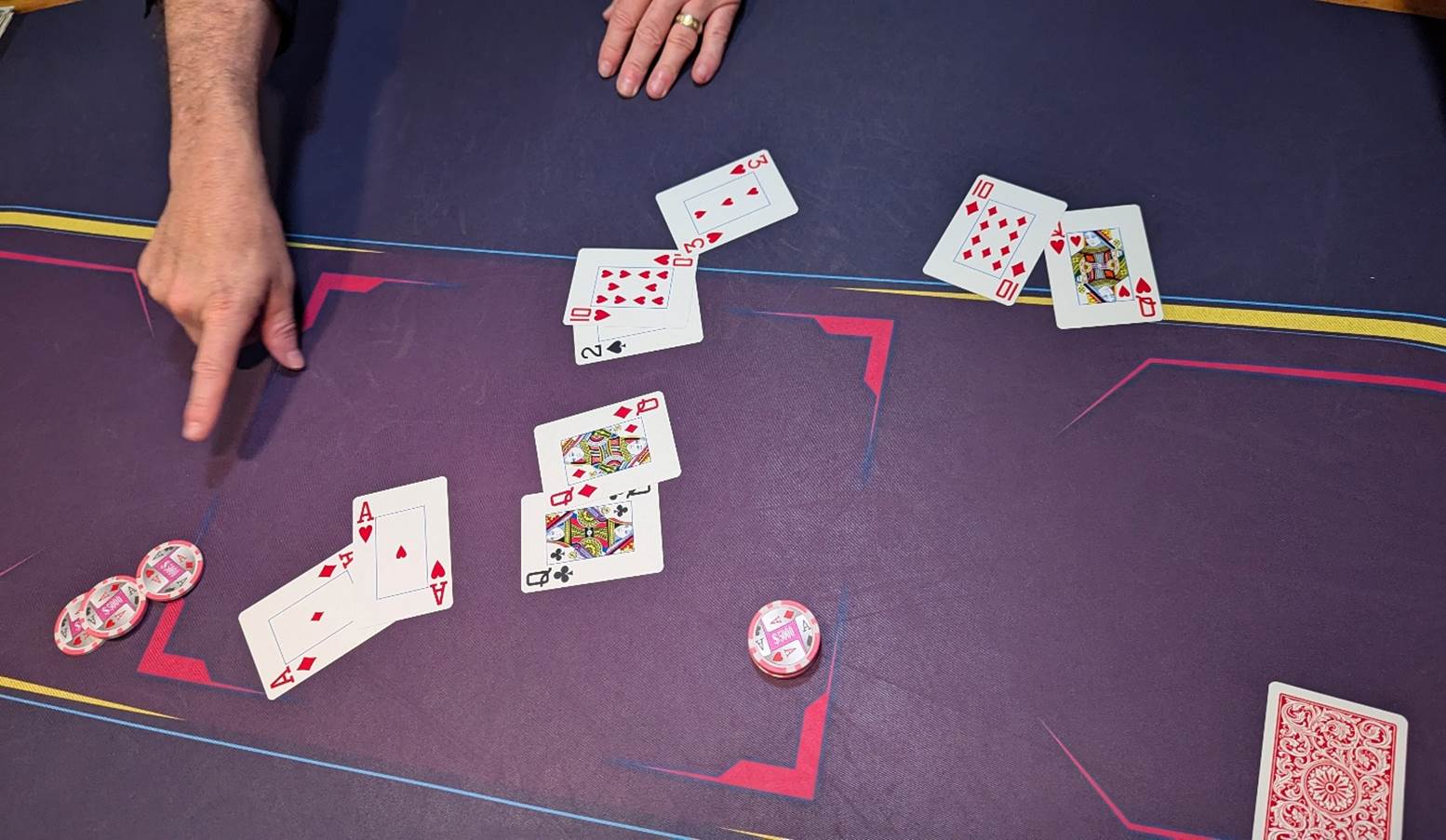 A person playing cards on a table

Description automatically generated