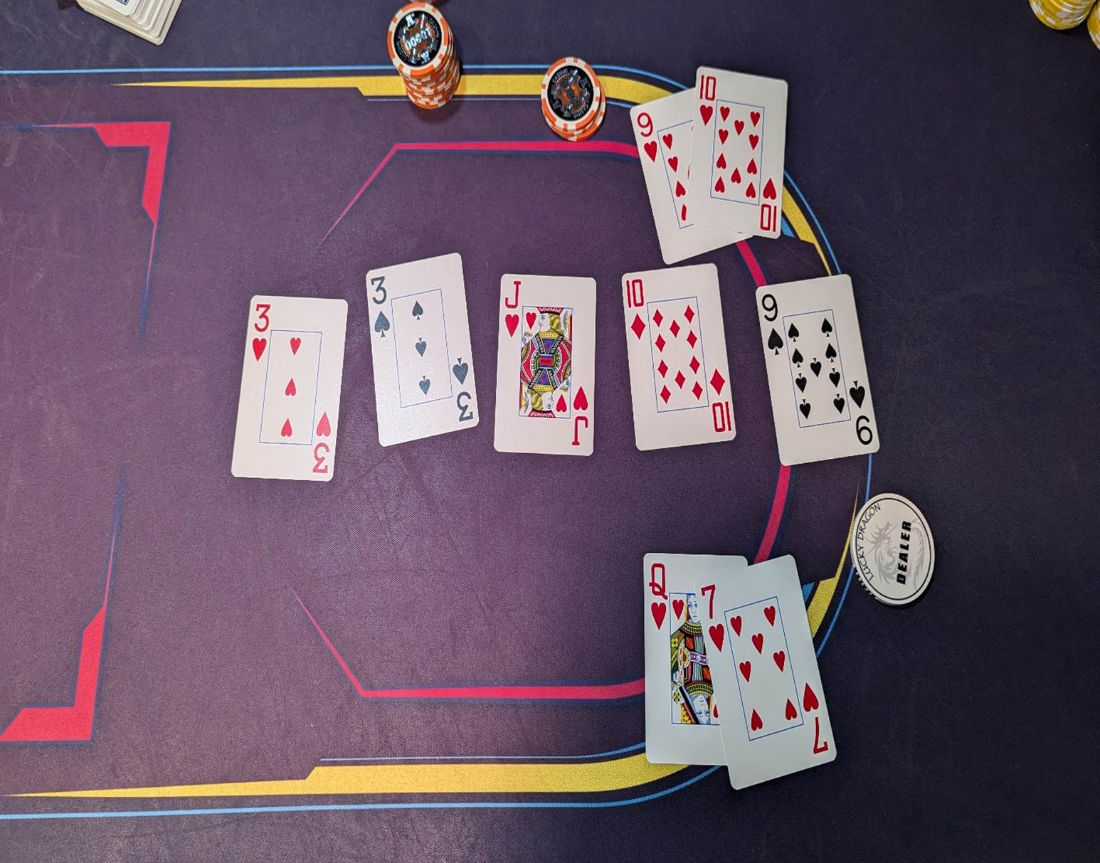 Playing cards on a table

Description automatically generated